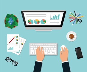 Overhead View of Desktop Computer with Hands Analyzing Reports and Charts on Blue Background