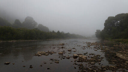 Morning September fog over a mountain river