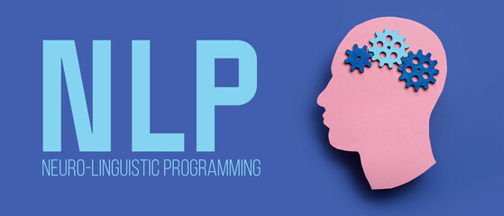 Paper human head with gears and word NLP (neuro-linguistic programming) on blue background