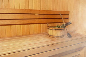 Interior of wooden sauna. Relax in hot sauna with steam. Interior of Finnish sauna classic wooden with hot steam. Wooden interior baths, wooden benches and loungers Accessories Sauna spa complex