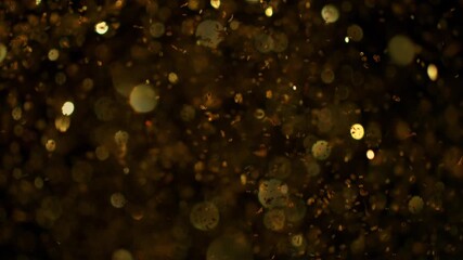 Super Slow Motion Shot of Glittering Golden Background at 1000fps. - Powered by Adobe