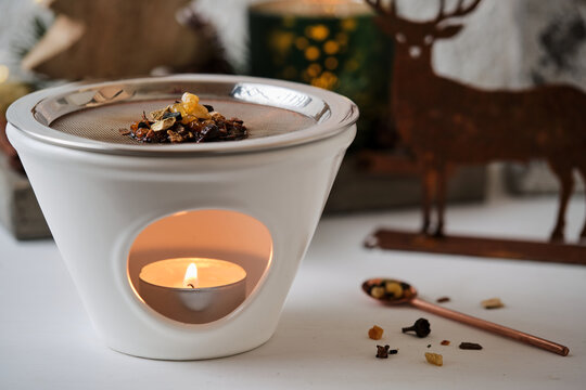 Close-up of Christmas incense ritual with herbs and resins