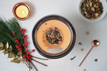 Overhead view of a Christmas incense ritual with herbs and resins