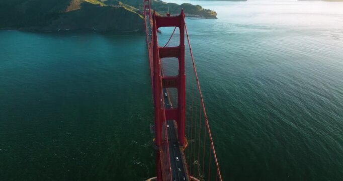 Aerial view of the Golden Gate Bridge with its striking red hue contrasting against the deep blue ocean, creating a stunning visual, San Francisco, California, United States.
