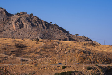 rocky desert landscape with scorched vegetation on the barren land of a rocky foothills