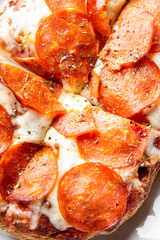 Close-up of pepperoni pizza with melted cheese, tomato sauce, and herbs on a thick crust. Classic fast food concept, ideal for menus, ads, or delivery promotions