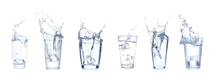 Set of many glasses with splashing water on white background