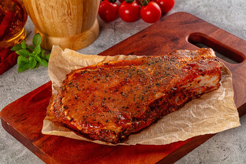 Raw marinated pork loin steak