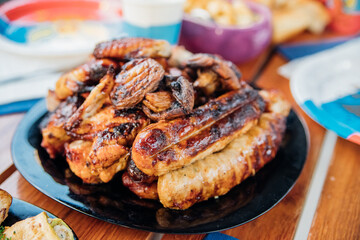Assorted meat kebabs and mushrooms served on a plate are ideal for a diet.