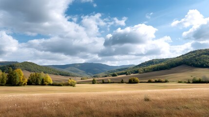 Fototapeta premium Serene autumn meadow with rolling hills and scattered trees