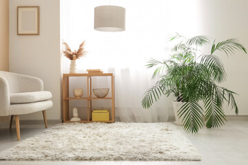 Interior of stylish living room with sofa, shelving unit and light curtains