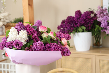 Beautiful bouquet with lilacs in florist studio