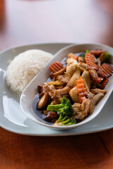 This dish is a flavorful Asian stirfry with vibrant vegetables and protein chicken, served hot with steamed rice