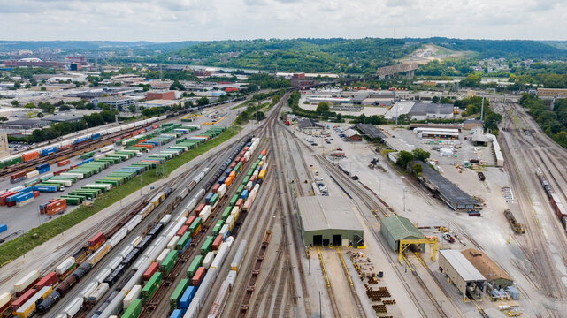 Cincinnati, United States - 22 August 2025: Aerial view of the sprawling rail yards and industrial complexes, a symphony of steel and concrete under a vast, clouded sky.
