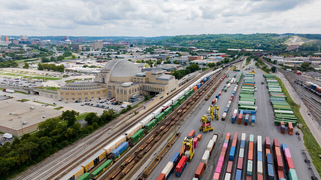 Cincinnati, United States - 22 August 2025: Aerial view of the iconic Cincinnati Union Terminal, its art deco architecture juxtaposed against the vibrant hues of stacked shipping containers.