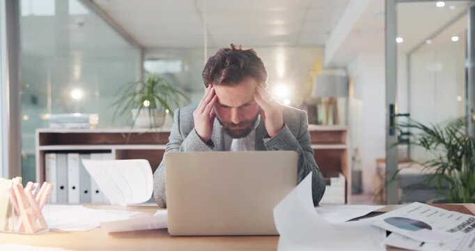 Business man, chaos and laptop with headache in office, falling papers and pressure with financial debt. Employee, investor and person in workplace, documents in air and tired with migraine and pain