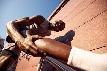Dedicated athlete stretching outdoors during an intense fitness routine for flexibility