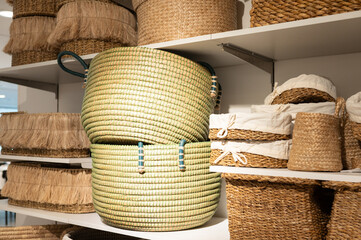 Assorted woven baskets on display shelf in home decor store