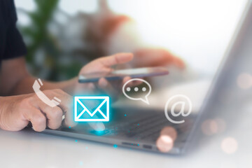 A person using laptop computer and cell phone contact customer support. help from mail websites...