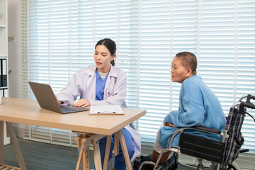 Elderly woman and caregiver or specialist nurse support kneels beside wheelchair, heartfelt conversation build trust communication while holding hands, boosting confidence recovery wellbeing in clinic