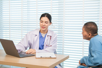 Elderly woman and caregiver or specialist nurse support kneels beside wheelchair, heartfelt conversation build trust communication while holding hands, boosting confidence recovery wellbeing in clinic