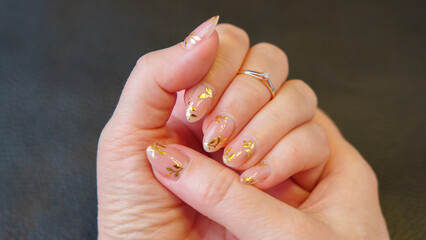 Great manicure, close-up photo. Female hands on a dark background.