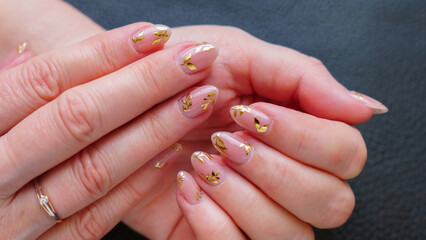 Great manicure, close-up photo. Female hands on a dark background.