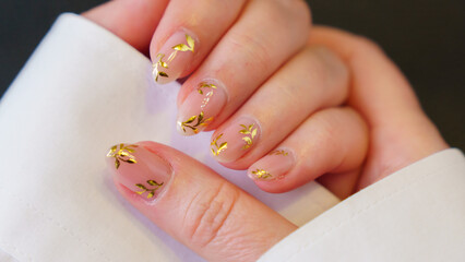 Great manicure, close-up photo. Female hands on a dark background.