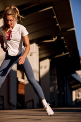 Young woman performing an outdoor workout in early morning sunlight