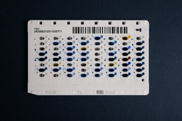 Basrah, Iraq - September 10, 2025: A Microfluidic Device with Colorful Liquid Samples for Lab