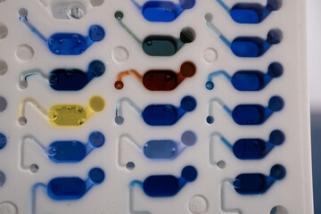 Basrah, Iraq - September 10, 2025: A VITEK 2 Microassay Card with Various Liquid Sample