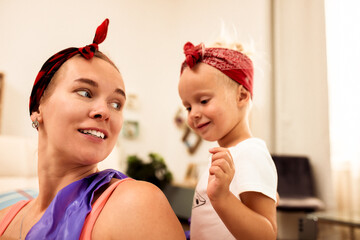 Happy mother and child enjoying playful moments together at home