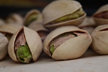 Close-up of opened pistachios showing green nuts.
