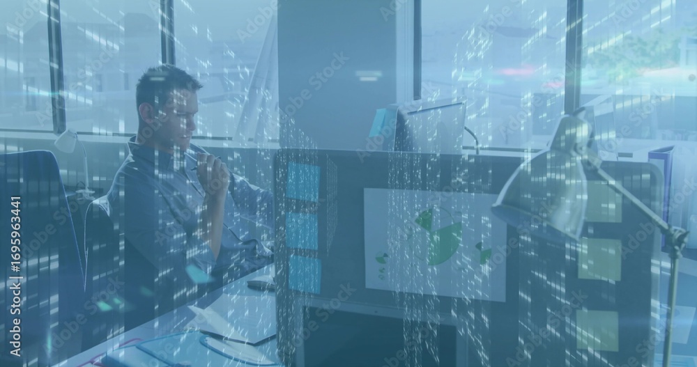 Poster analyzing worker in button-down shirt studying data flow at cubicle, with monitor, lamp, copy space