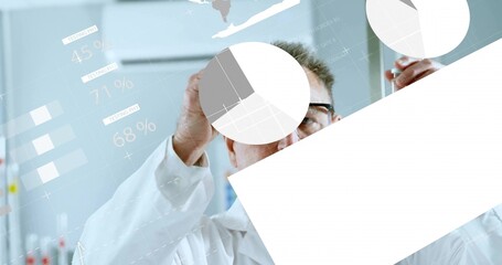 Pointing scientist wearing lab coat, eyeglasses analyzing digital pie charts on glass panel in lab