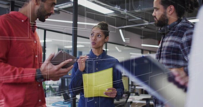 3 coworkers exchanging ideas in office space using smartphone folder pen laptop headphones monitors