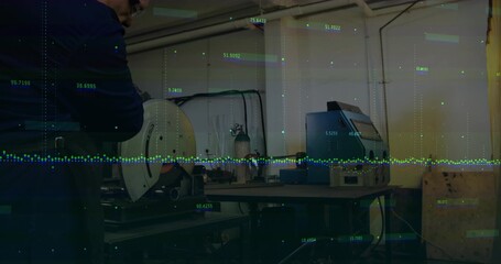 Worker wearing safety glasses grinding on bench grinder in workshop, with data overlays, copy space
