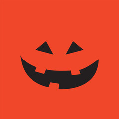Carved pumpkin face on orange background