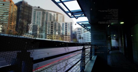 Speeding commuter train blurring across modern urban rail platform, with perforated safety screen