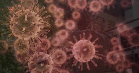 Standing man wearing protective suit and medical face mask in glass entrance, with virus graphics