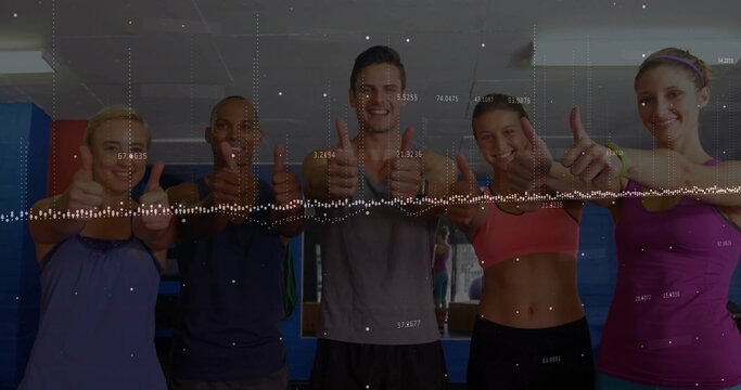 Giving thumbs-up adults in sportswear standing in fitness studio with wall mirror and data overlay