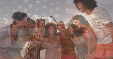 Laughing group of friends huddling shoulders on sandy beach under palm fronds, with flag overlay