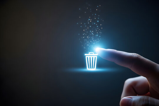 Finger touching glowing digital trash can icon with particles floating up
