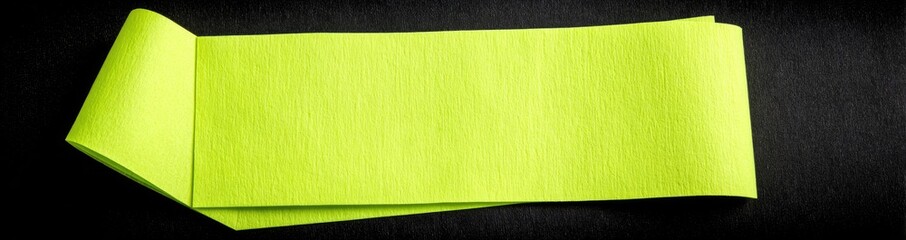 Two bright lime green sticky notes overlapping on a dark surface