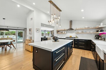 Bright modern kitchen with center island, pendant lighting, and open concept design in a luxury home
