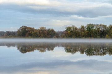 Autumn river foggy landscape, autumn mist at the river, foggy landscape with water reflections