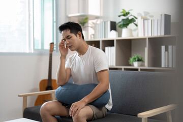 Mindfulness Moment. Young man practicing mindfulness while seated on a couch.