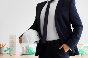 Male architect with hardhat in office