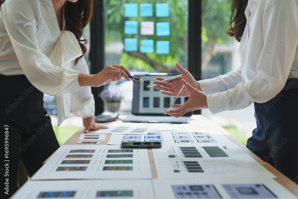 Poster web designers working on user interface and user experience of mobile application
