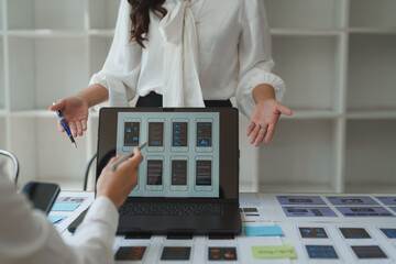 Ux ui designers discussing mobile app interface design on laptop
